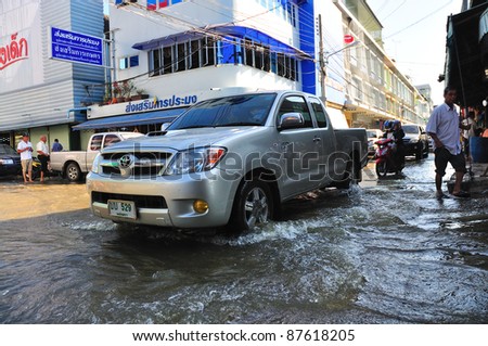 CHACHOENGSAO, THAILAND - OCTOBER 29:  Driving car in rising tide from Bangpakong River in October 29, 2011 in Chachoengsao, Thailand.