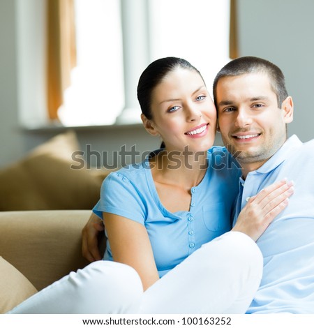 Portrait of young happy smiling attractive cheerful couple at home