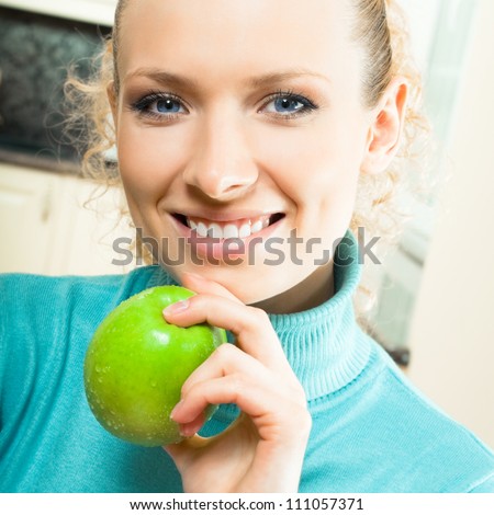 Young happy smiling beautiful blonde woman with apple