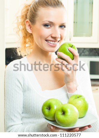 Young happy smiling beautiful blonde woman with apples
