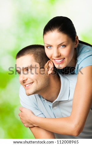 Portrait of young happy smiling attractive couple, outdoors