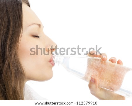 Happy smiling young woman in fitness wear with bottle of water, isolated over white background