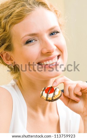 Cheerful woman eating cookies