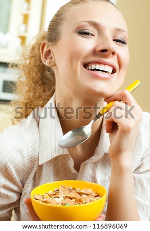 Cheerful blond woman eating cereal muslin