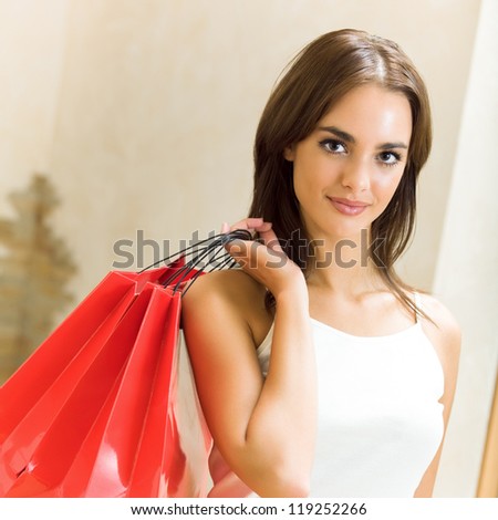 Young happy smiling attractive woman with shopping bags