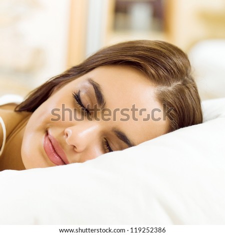 Young beautiful woman sleeping on bed