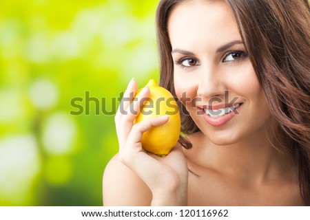 Young happy smiling woman with limon, outdoors, with copyspace for text or slogan