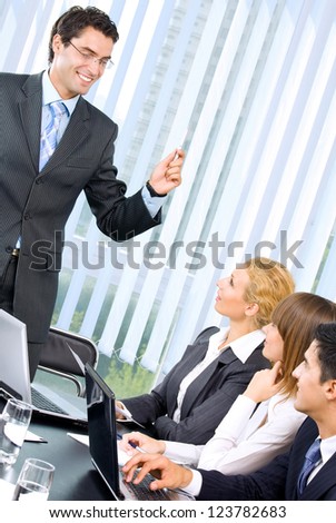 Cheerful businesspeople at business meeting, seminar, conference or training