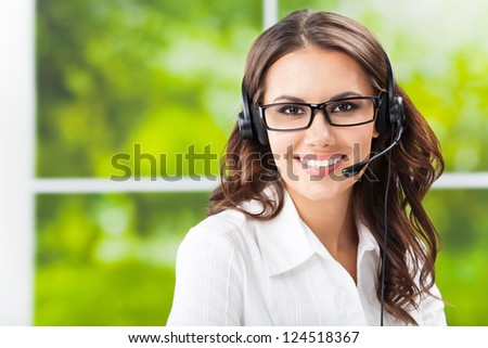 Portrait Of Happy Smiling Cheerful Beautiful Young Support Phone Operator In Headset, At Office, With Copyspace