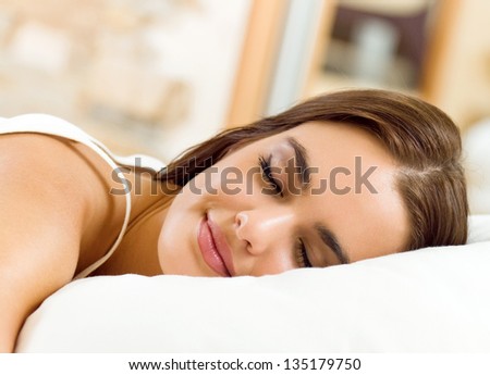 Young beautiful woman sleeping on bed