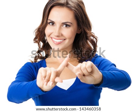 Smiling young woman showing stop gesture, by crossing fingers, isolated over white background