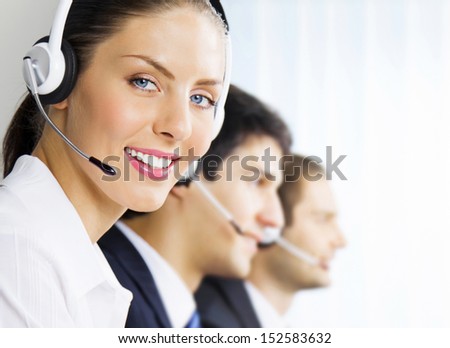 Three Happy Smiling Young Customer Support Phone Operators At Workplace