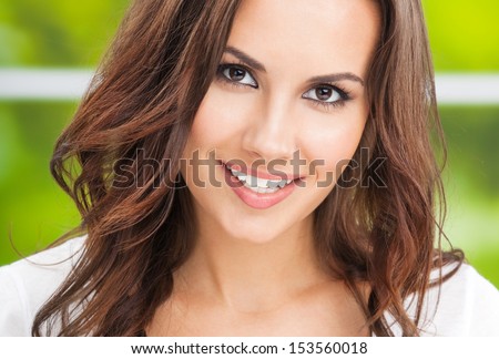 Portrait of beautiful young happy smiling woman, outdoors
