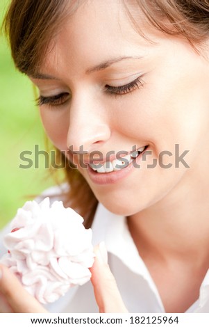 Cheerful smiling business woman with cake outdoor