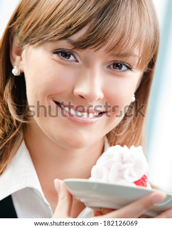 Cheerful smiling business woman with cake at office