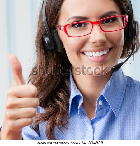 Support phone operator in headset, showing thumbs up gesture