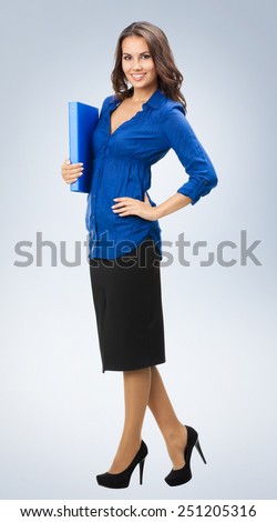 Full body portrait of smiling businesswoman with blue folder
