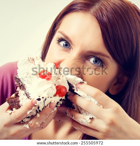 Portrait of young hungry woman eating pie
