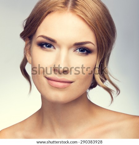 Portrait of beautiful young woman with naked shoulders. Beauty and health concept.