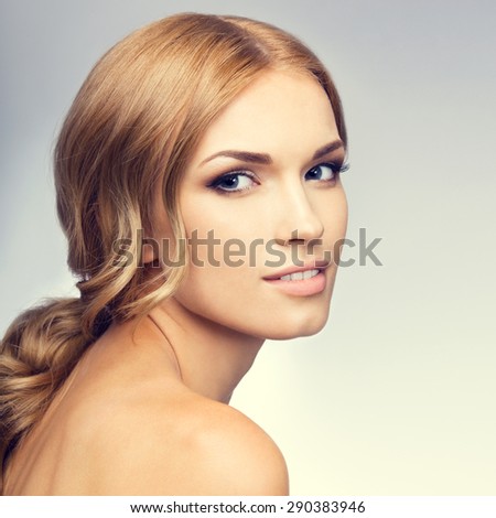 Portrait of beautiful young blond woman with naked shoulders. Beauty and health concept.