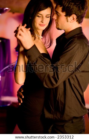 Young couple dancing at the restaurant or cafe