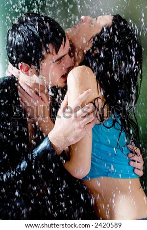 young couple kissing in rain. stock photo : Young couple