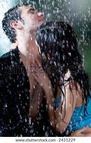 romantic couple kissing in rain. romantic couple kissing in the