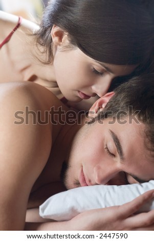 Couple kissing and hugging on the bed in bedroom