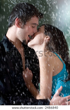 couple kissing in rain. kissing under a rain, in