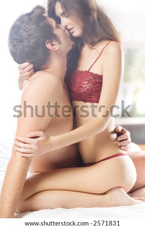 stock photo Couple kissing and hugging on bed in bedroom in passion