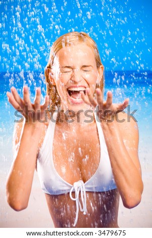 stock photo Young beautiful happy smiling tanned blond woman in bikini at