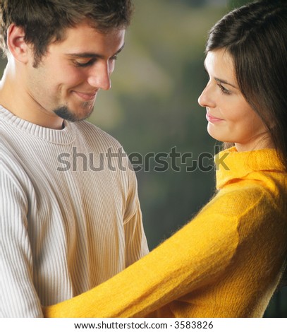 Playful young happy smiling attractive couple embracing, outdoors