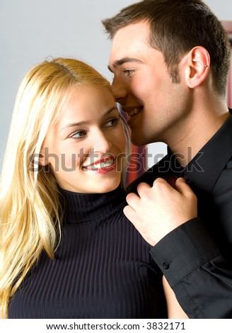 couple telling a secret,