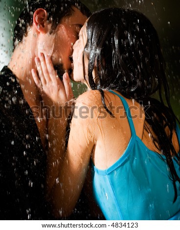 romantic couple kissing in the rain. amorous couple kissing and