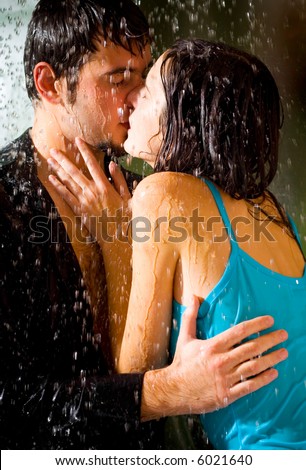 couple kissing in the rain. Young happy couple kissing