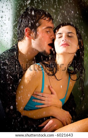 young couple kissing in rain. Young happy couple kissing