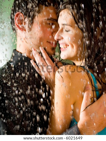couple kissing in rain. Young happy couple kissing