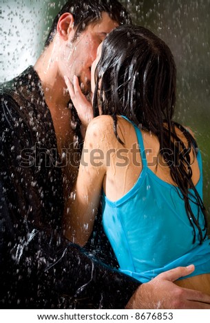young couple kissing in rain. stock photo : Young hugging