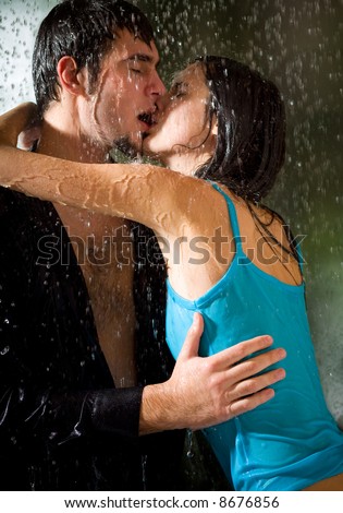 romantic couple kissing in the rain. hugging couple kissing