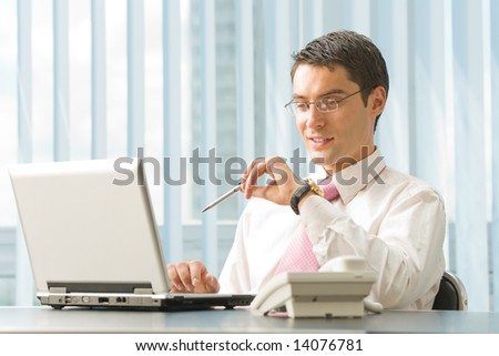 Portrait of happy smiling businessman with laptop at office