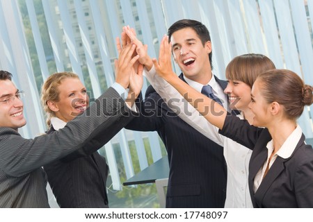 Happy successful gesturing business team at office