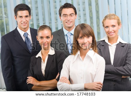 Portrait of cheerful successful business team at office