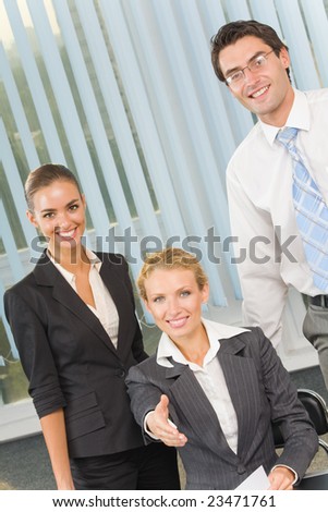 Portrait of cheerful successful business team at office