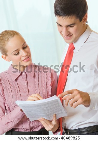 Photo of two happy business people in office