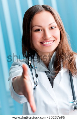 Happy female doctor giving hand for handshake, at office