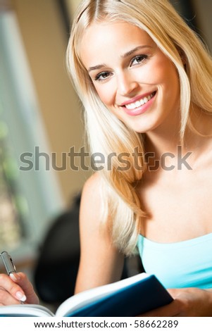 Young woman with notebook or organiser at home