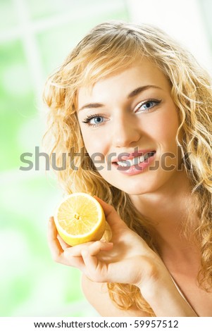 Young happy smiling woman with lemon