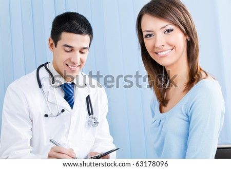 Happy female patient and doctor at office
