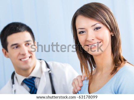 Happy female patient and doctor at office. Focus on woman.