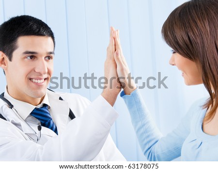 Happy doctor and female patient at office